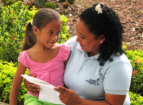 Volunteer Pilar Ayala reads a letter to a girl in Guayaquil