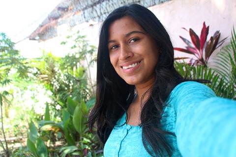 Lucy takes a selfie while wearing an aqua blue dress.