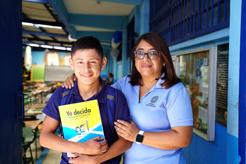 a boy and and a woman smiling to the camera