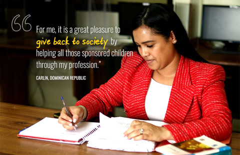 a woman sitting at a desk writing