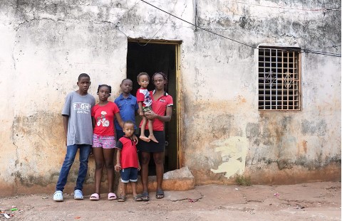 a family standing outside of their home