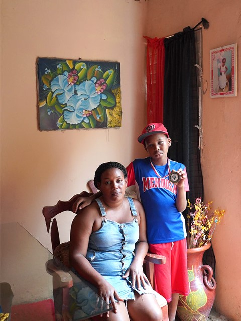 a woman and a boy inside their home
