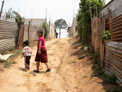 two girls walking down a dirt road